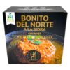 Spanischer Bonito del Norte in Sidra, 280 g, mit frischer Zitrone und grüner Minze, auf einer schwarzen Verpackung.