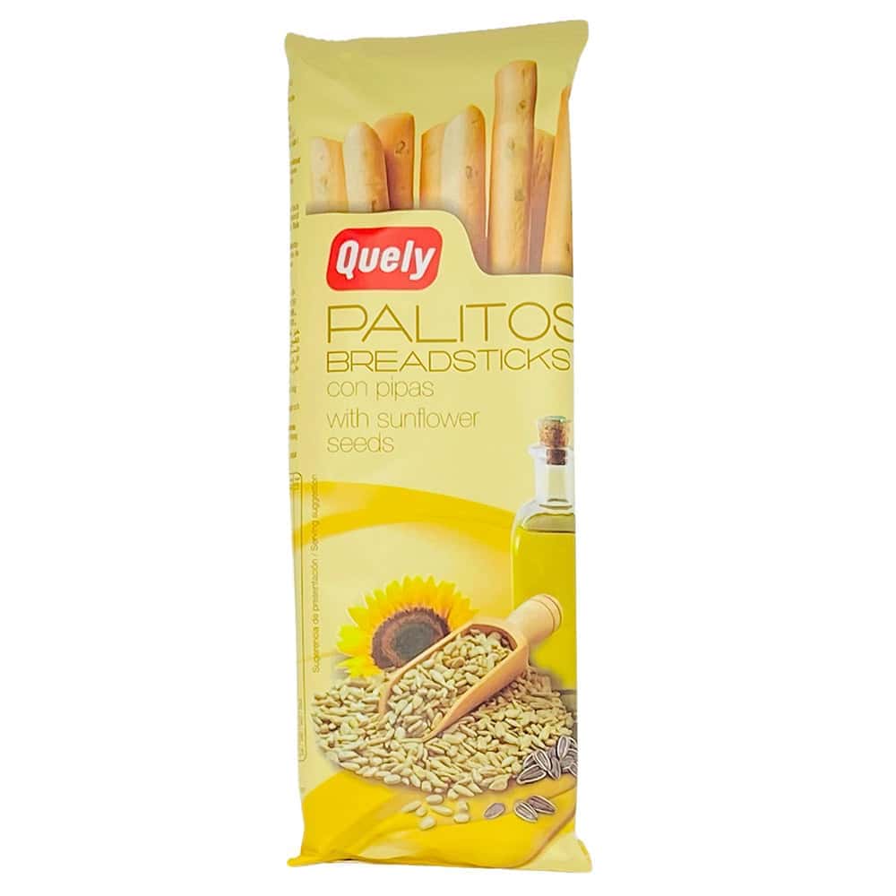Brotsticks mit Sonnenblumenkernen in gelber Verpackung, Quely-Marke, mit Sonnenblumen und Sonnenblumenkernen im Vordergrund.